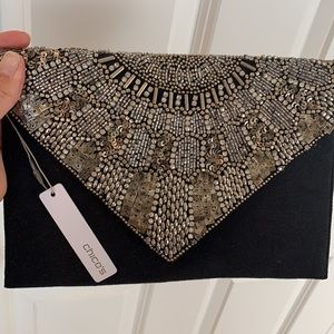 Chico’s black clutch, wrist strap/shoulder